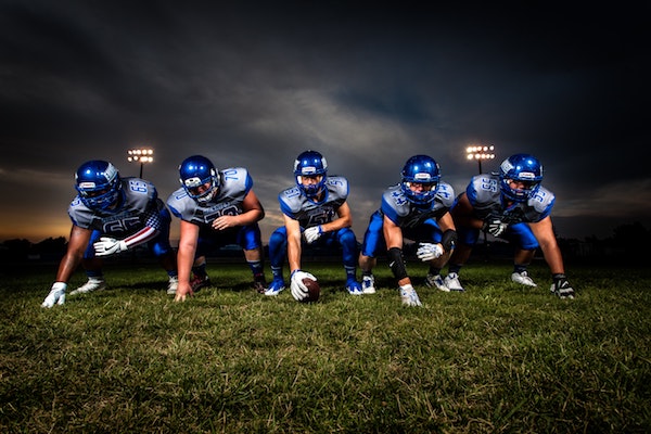 football-players-in-blue-jersey-lined-under-grey-white-186076.jpg